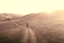 a man walking on a path on a mountainside 