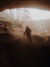 Men exploring a cave. 