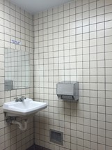 sink, mirror, and hand dryer in a public bathroom 
