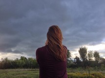 woman and an approaching storm 