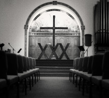 row of chairs in a church and altar 