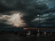 gray clouds over a gas station 