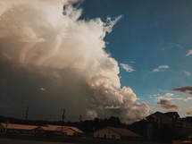 clouds over houses in a neighborhood 