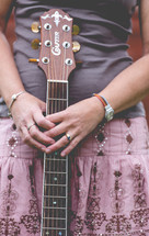 woman holding a guitar 