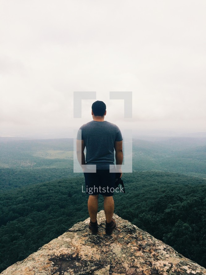 man standing at the edge of a cliff 