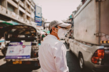 a man wearing a face mask walking on a street 