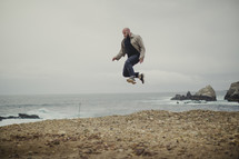 man jumping on the beach