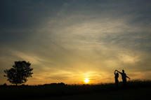 silhouette of a couple dancing outdoors 