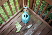 gardening tools on a porch deck 