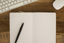 Blank open journal on a desktop.