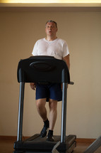 Middle-aged man working out on a treadmill