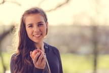 teen girl holding an apple 