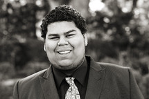 A smiling young man in a shirt and tie Samoan 