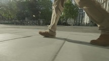 Low angle steady cam view of a man walking
