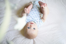 a baby in a round crib looking up 