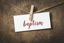 word baptism on white card stock hanging from a clothespin on a clothesline 
