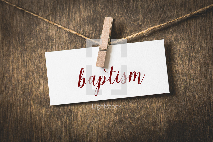 word baptism on white card stock hanging from a clothespin on a clothesline 