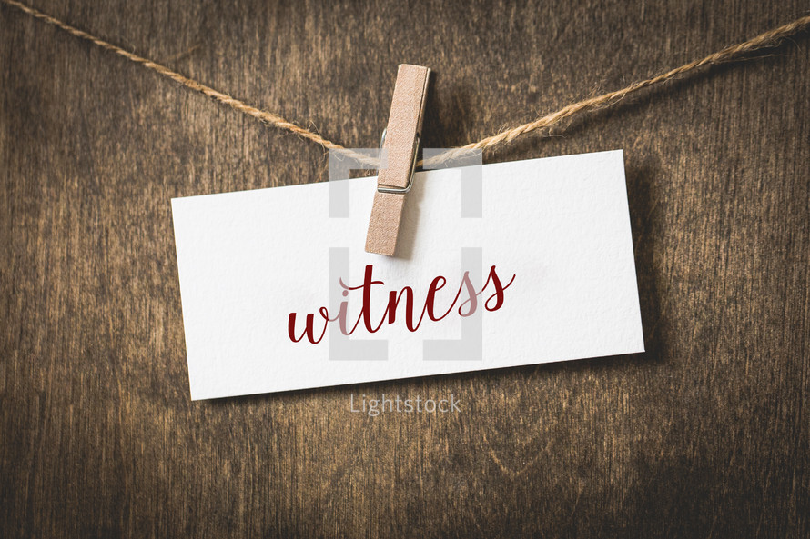 word witness on white card stock hanging from a clothespin on a clothesline 