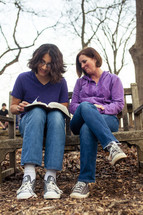A young man and a woman reading a Bible - mentoring 