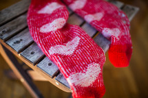 Red socks with heart pattern on wooden chair