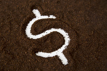 money symbol in coffee grounds 