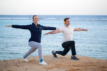Young couple working out outdoor with music