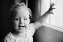 Portrait of happy one year old girl in black and white