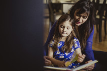 mother and daughter reading together