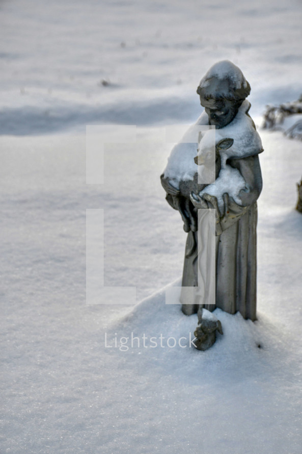 statue of Saint Francis in the snow 