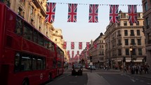 Day to night time-lapse of Regent street London England decorated with Union jack flags