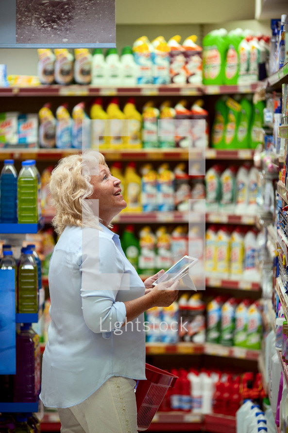 A smiling middle aged woman in a household section 