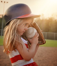 a little girl playing baseball 