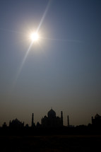 the sun shines bright above the Taj Mahal