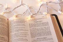 Christmas lights on an open Bible 