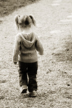 toddler girl in pig tails walking 