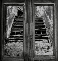 looking through door frames at broken stairs