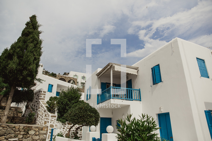 covered balcony on a white and blue house in Greece 