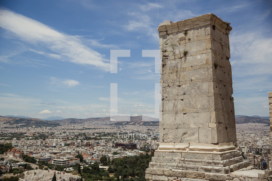 view of a city in Greece and a column 