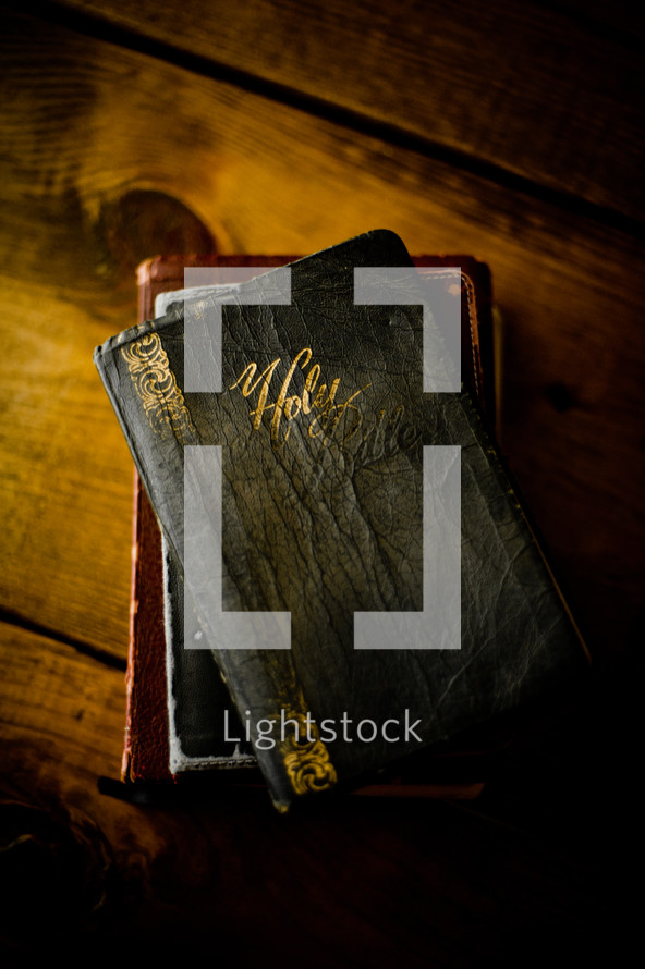 worn Bible on a wood table 