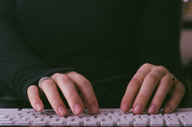 woman typing on a keyboard