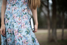 young woman carrying a Bible at her side 