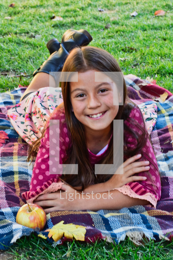 young girl on a fall blanket 