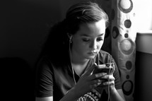 girl looking at her smart phone, teen listening to music, iphone, 