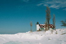 lighthouse covered in snow 