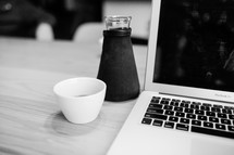 flask, coffee mug, and laptop computer 