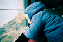 Toddler child gazing out the window.