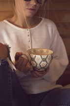 a young woman holding a tea cup 