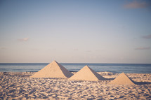 building pyramid sand castles on a beach 