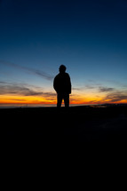 silhouette of a man at dusk 
