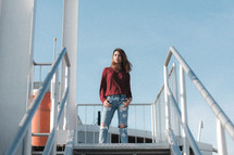 a woman standing on stairs posing 